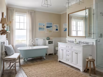 AI-generated coastal bathroom interior design: a white slipcovered sofa with sea-glass blue and striped cushions