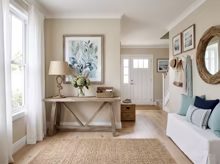 AI-generated coastal entryway interior design: a white slipcovered sofa with sea-glass blue and striped cushions