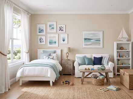 AI-generated coastal kids room interior design: a white slipcovered sofa with sea-glass blue and striped cushions