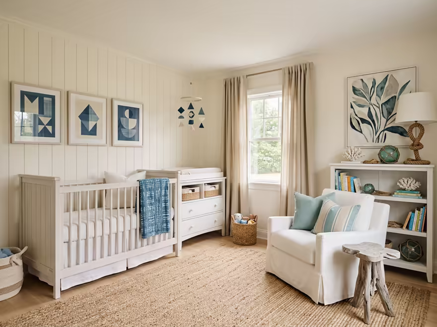 AI-generated coastal nursery interior design: a white slipcovered sofa with sea-glass blue and striped cushions