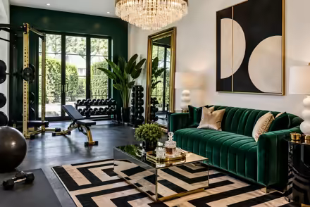 AI-generated hollywood regency home gym interior design: glamorous and graphic: one channel-tufted sofa in emerald or sapphire velvet