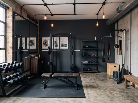 AI-generated industrial loft home gym interior design: black steel and aged leather furniture