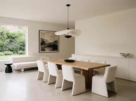 AI-generated minimalist dining room interior design: an almost empty room done perfectly: one exceptional low sofa in off-white