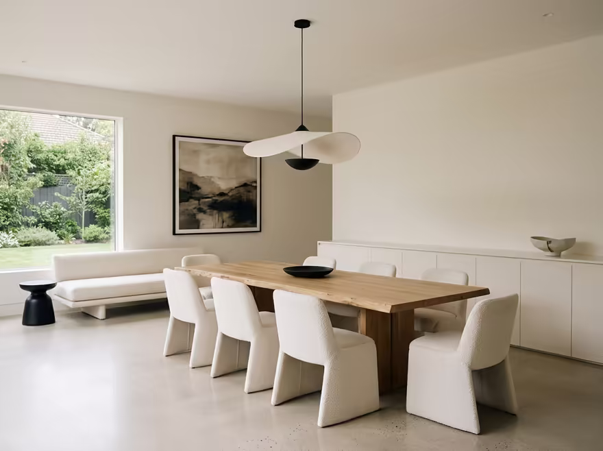 AI-generated minimalist dining room interior design: an almost empty room done perfectly: one exceptional low sofa in off-white
