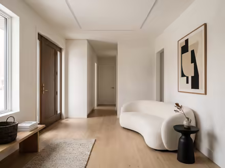 AI-generated minimalist entryway interior design: an almost empty room done perfectly: one exceptional low sofa in off-white