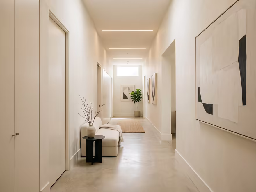 AI-generated minimalist hallway interior design: an almost empty room done perfectly: one exceptional low sofa in off-white