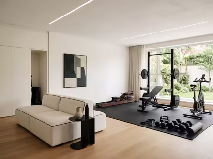 AI-generated minimalist home gym interior design: an almost empty room done perfectly: one exceptional low sofa in off-white