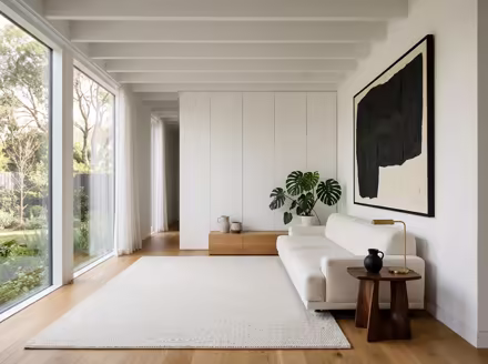 AI-generated minimalist living room interior design: an almost empty room done perfectly: one exceptional low sofa in off-white