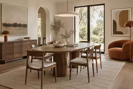 AI-generated scanditalia dining room interior design: Scandinavian restraint with Italian warmth: one curved sofa in terracotta or ochre boucle