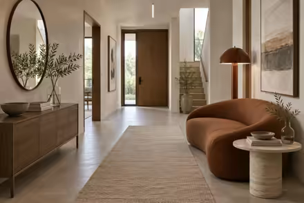 AI-generated scanditalia hallway interior design: Scandinavian restraint with Italian warmth: one curved sofa in terracotta or ochre boucle
