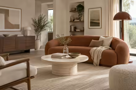 AI-generated scanditalia living room interior design: Scandinavian restraint with Italian warmth: one curved sofa in terracotta or ochre boucle