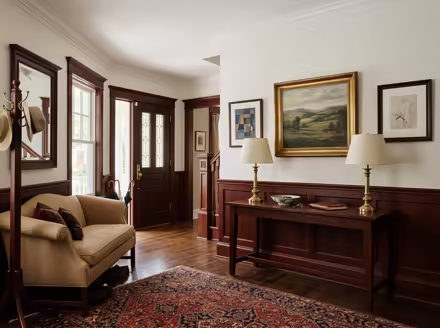 AI-generated traditional entryway interior design: a classic rolled-arm sofa in warm neutral upholstery