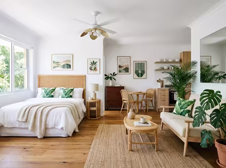 AI-generated tropical studio apartment interior design: rattan and bamboo furniture
